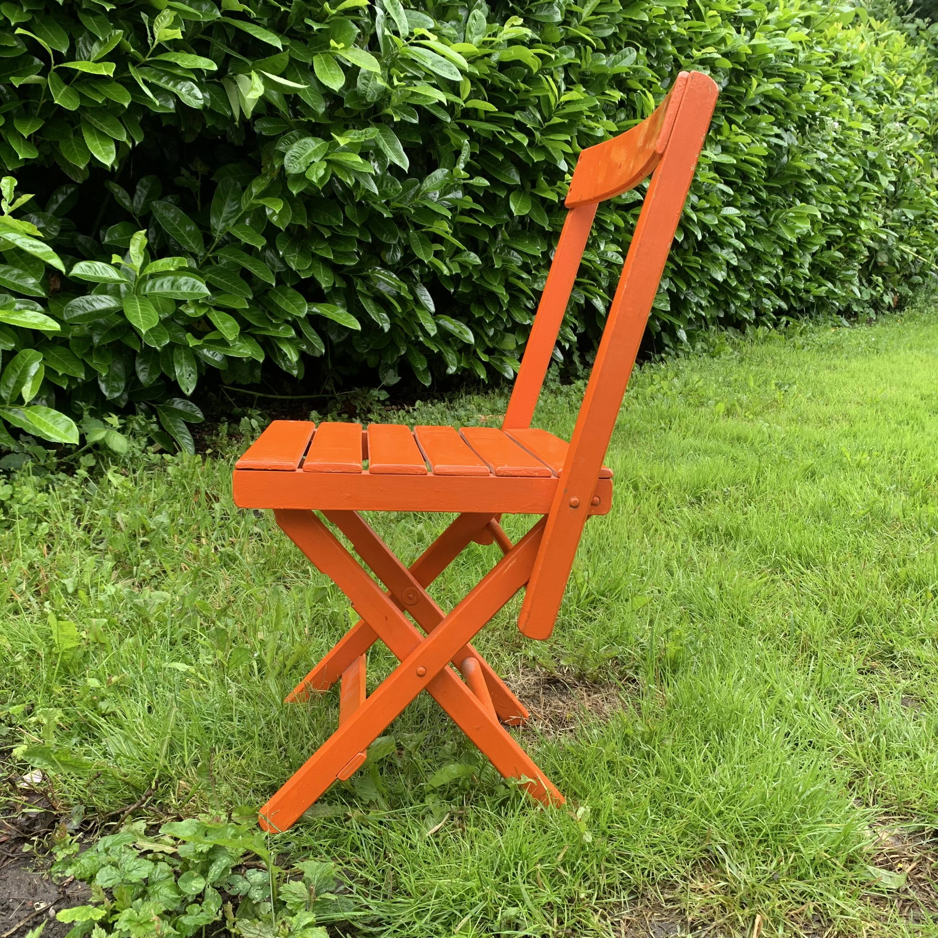 Vintage folding chair in orange painted wood
