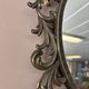 Miroir en bronze à volutes style rocaille