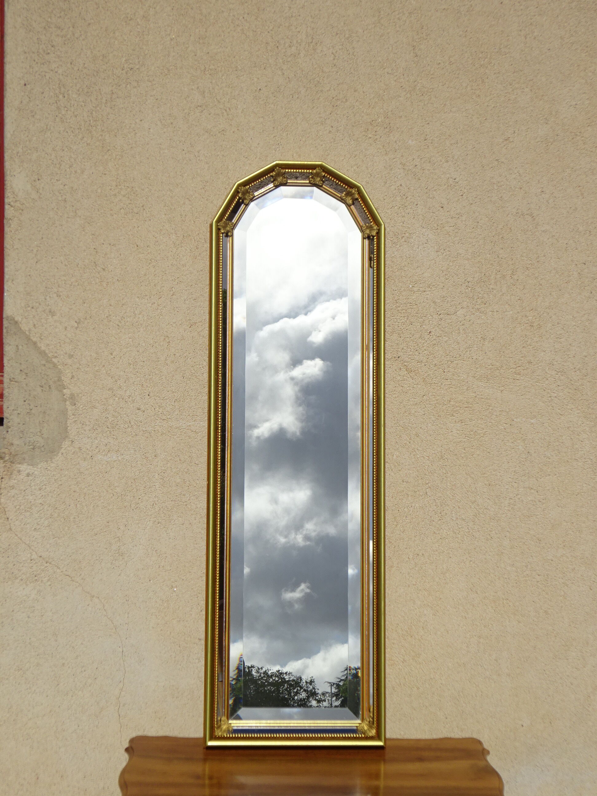 Vertical mirror, gold frame with beading.