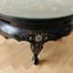 Asian coffee table in Chinese style made of black and gold lacquered wood.