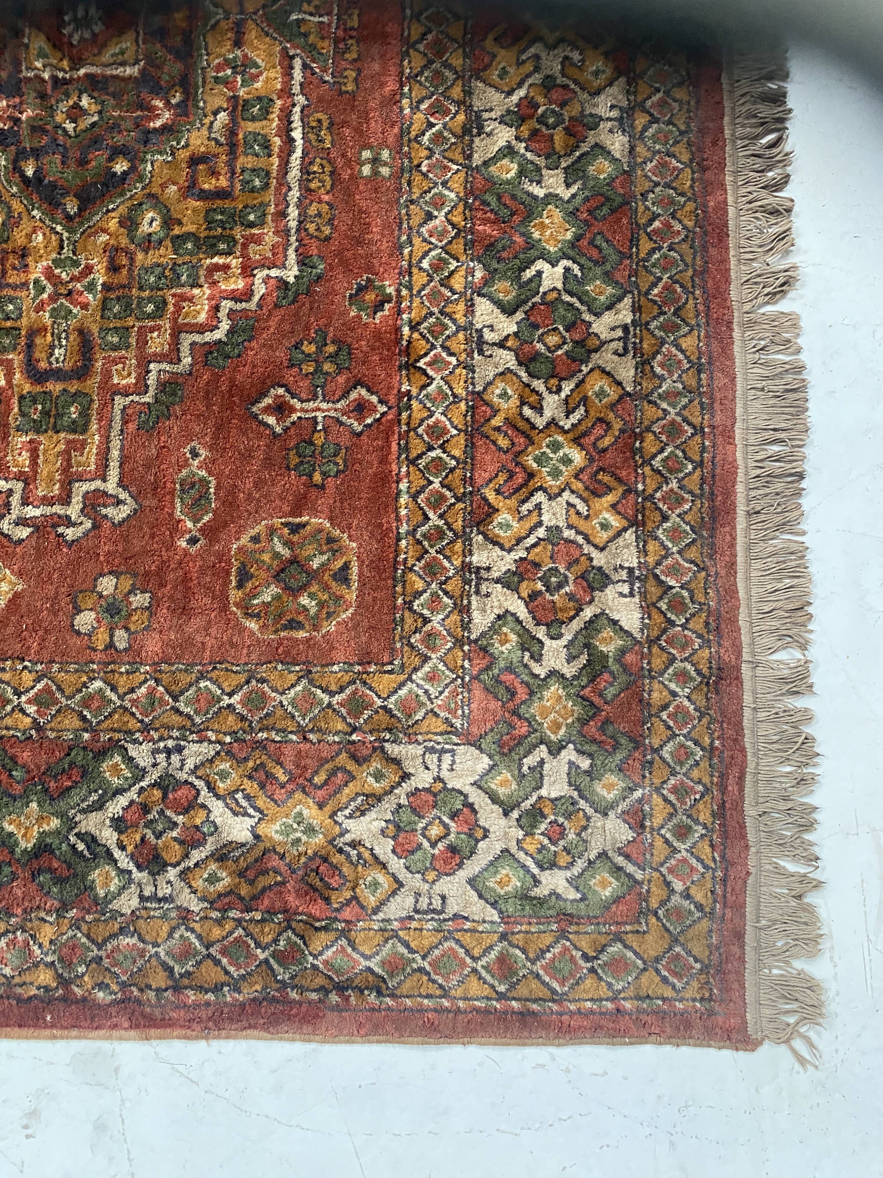 Antique wool rugs with designs on a red background, 20th century.