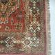 Antique wool rugs with designs on a red background, 20th century.