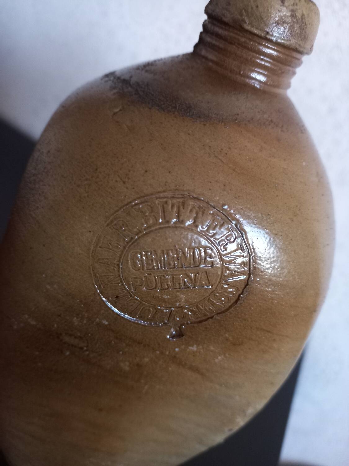 Old bottle of mineral water in salt stoneware
