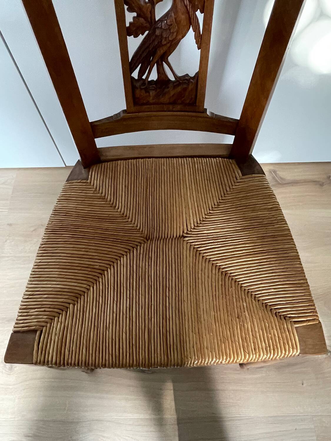 19th century straw chair with carved peacock back