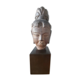 Head of Buddha on wooden base. Resin sculpture from Japan
