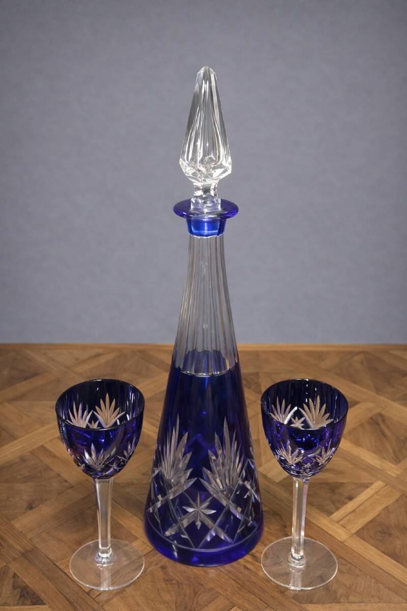 Cobalt blue double crystal service, consisting of a decanter and two matching glasses.
