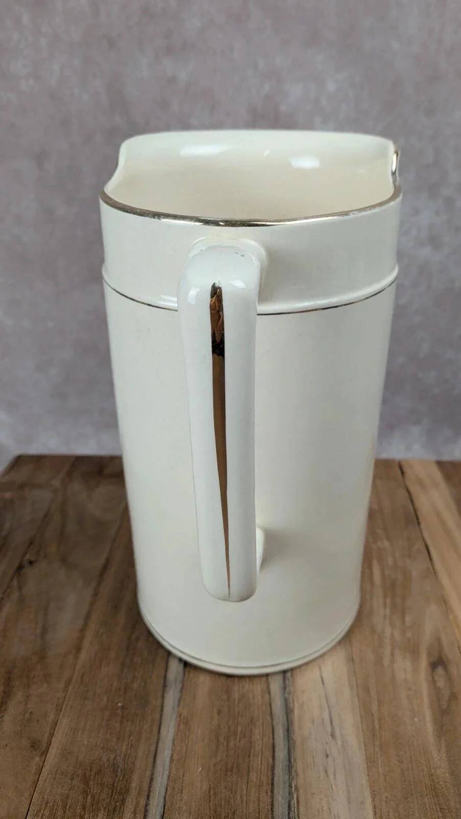 Large antique jug from Sarreguemines with golden trim.