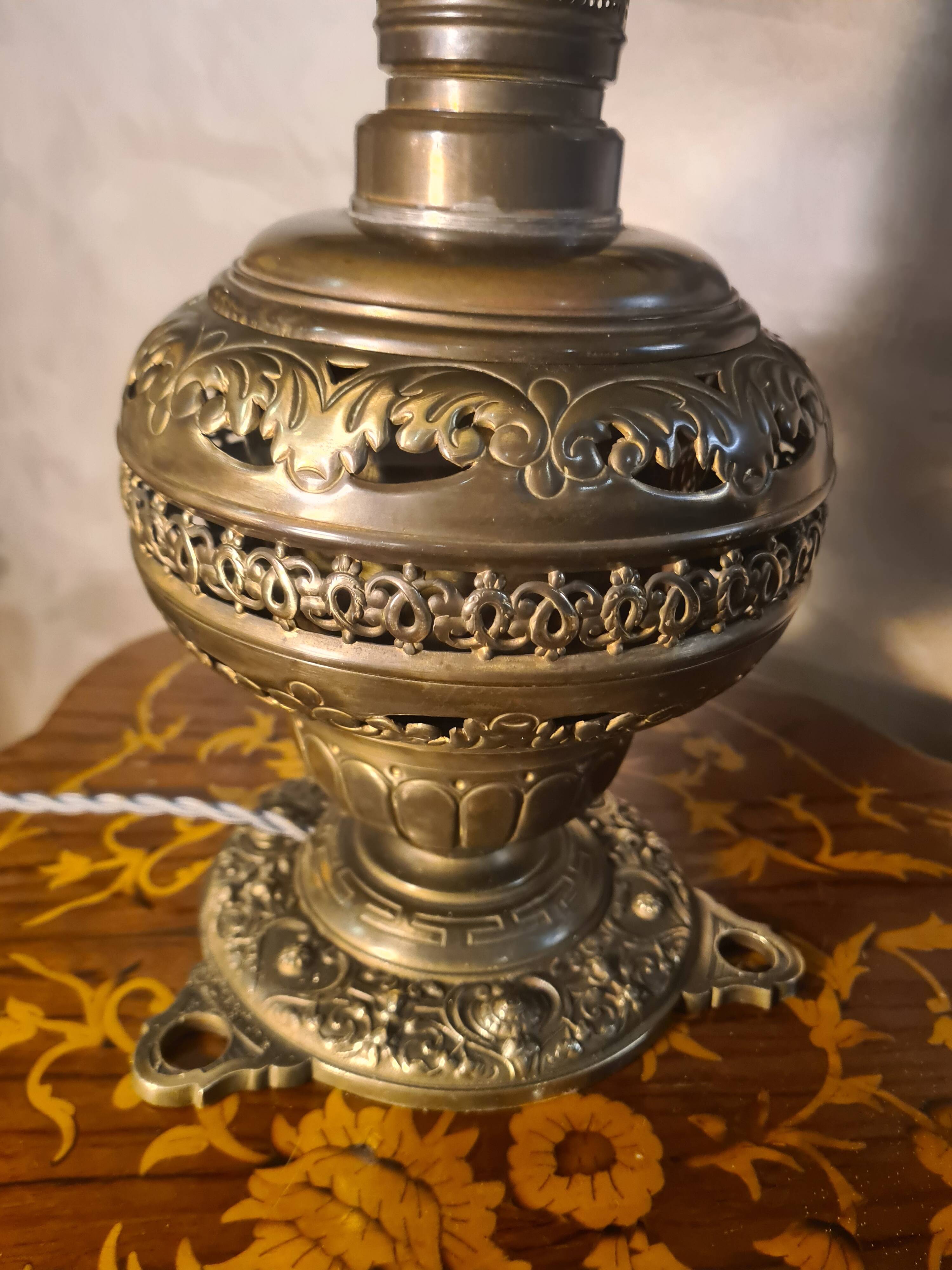 brass and bronze lamp with an antique base from 1900 and a glass paste shade