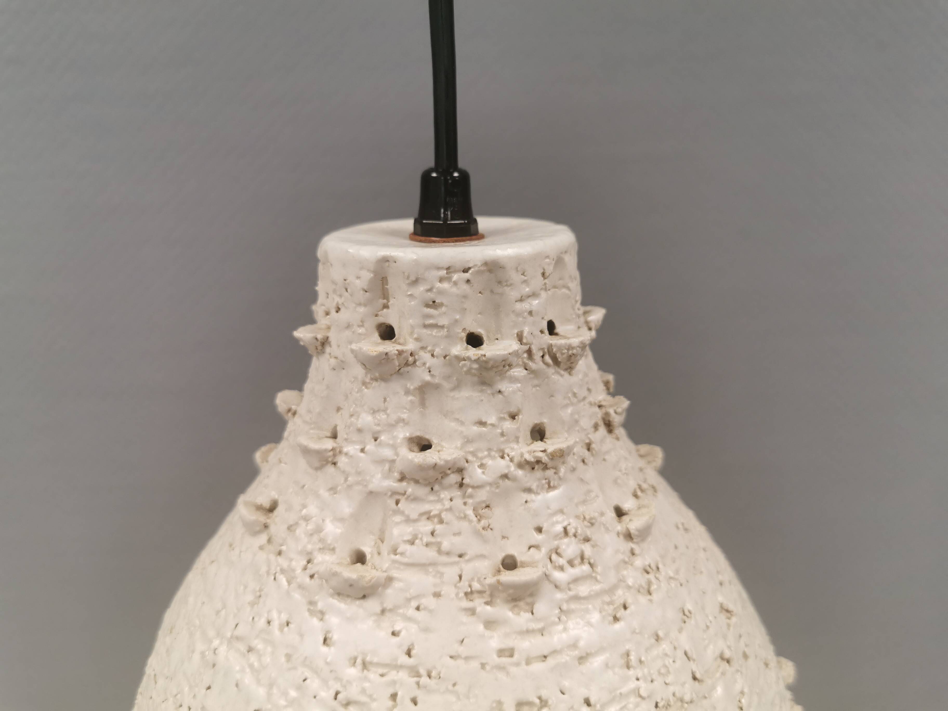Ceramic hanging lamp in creamy white color that almost looks like a corral