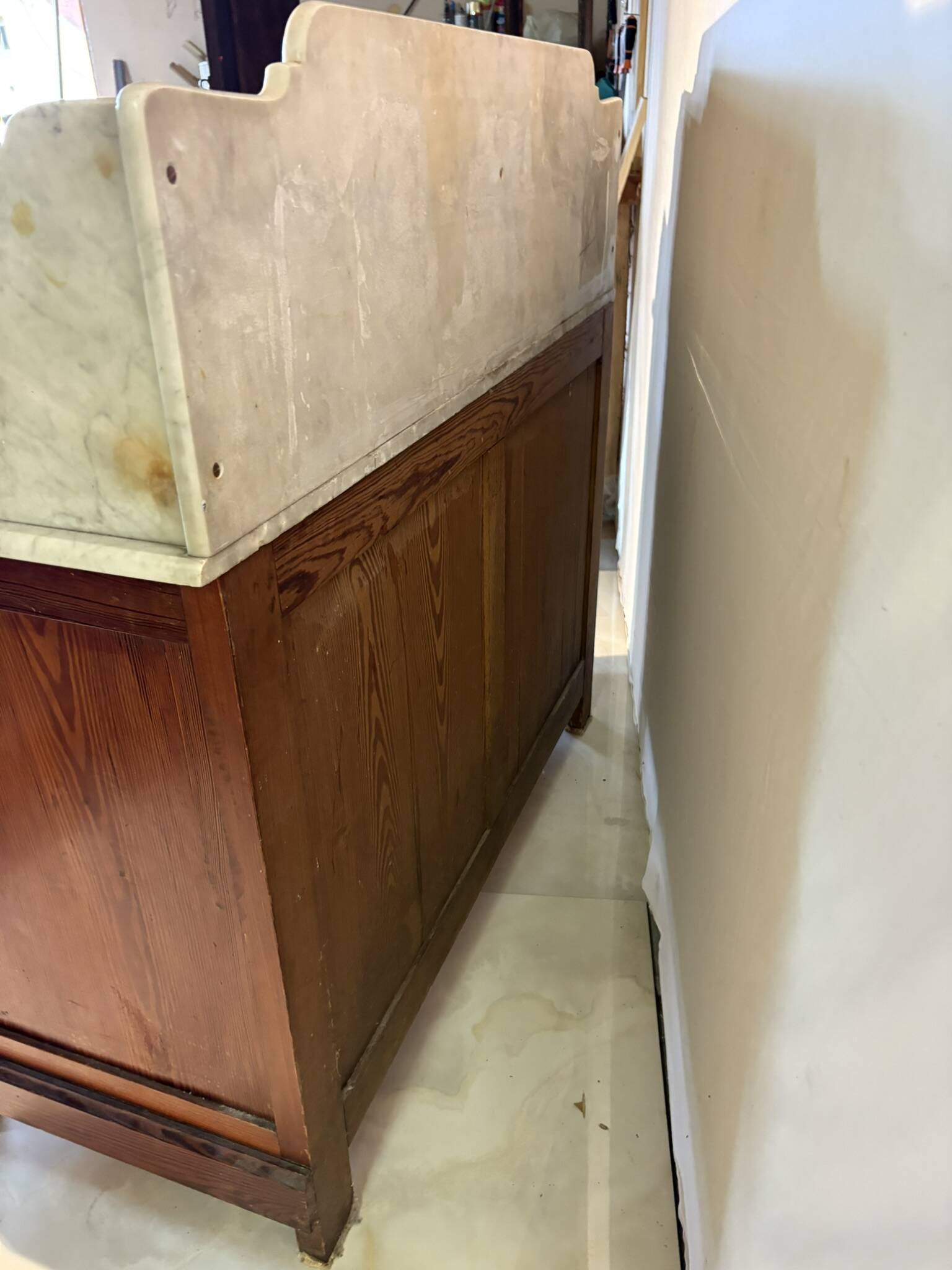 Antique wood and marble kitchen sideboard with carved backsplash