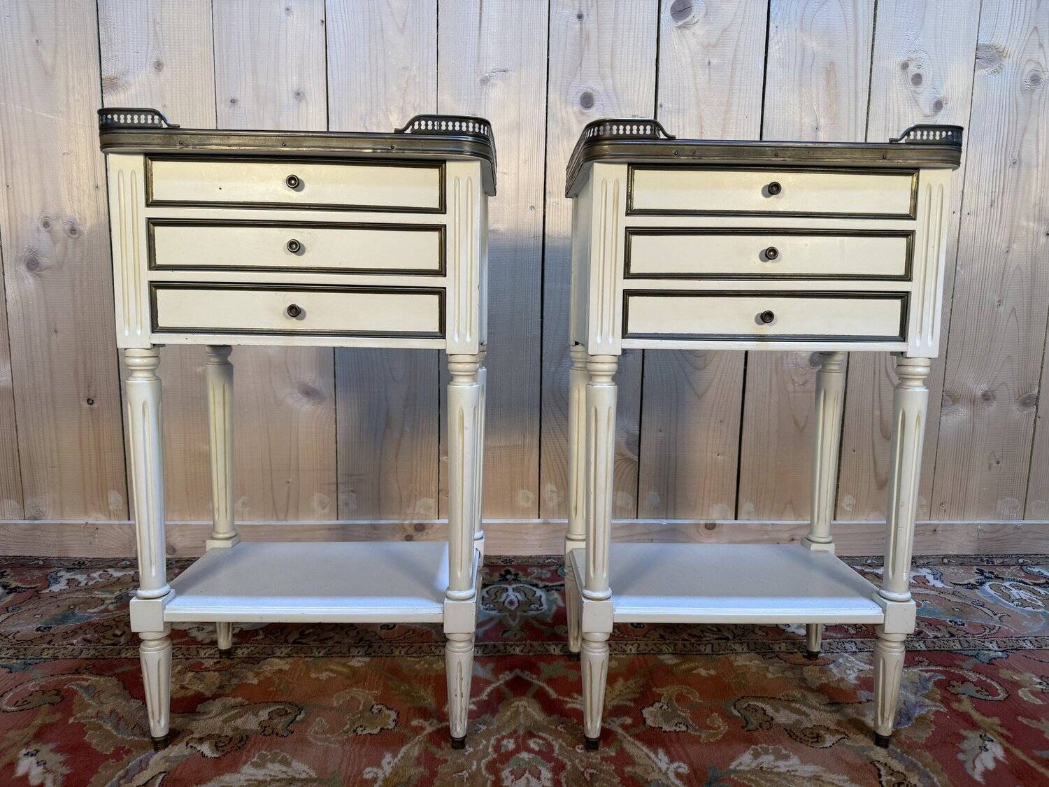 Pair of Louis XVI style bedside tables painted white.