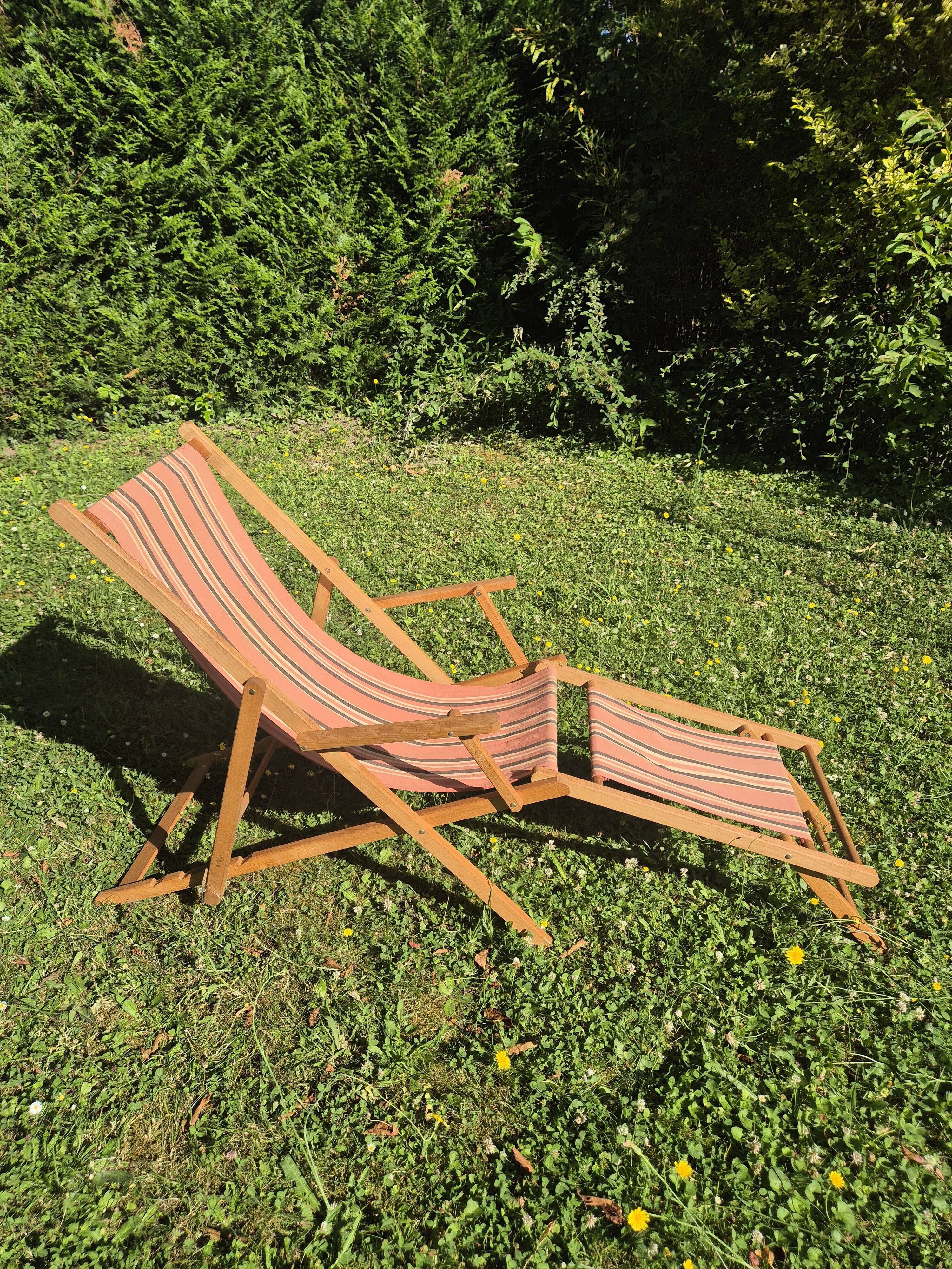vintage wooden deck chair with striped fabric and footrest