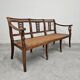 Directoire canapé in walnut with brass inlays, late 18th century.