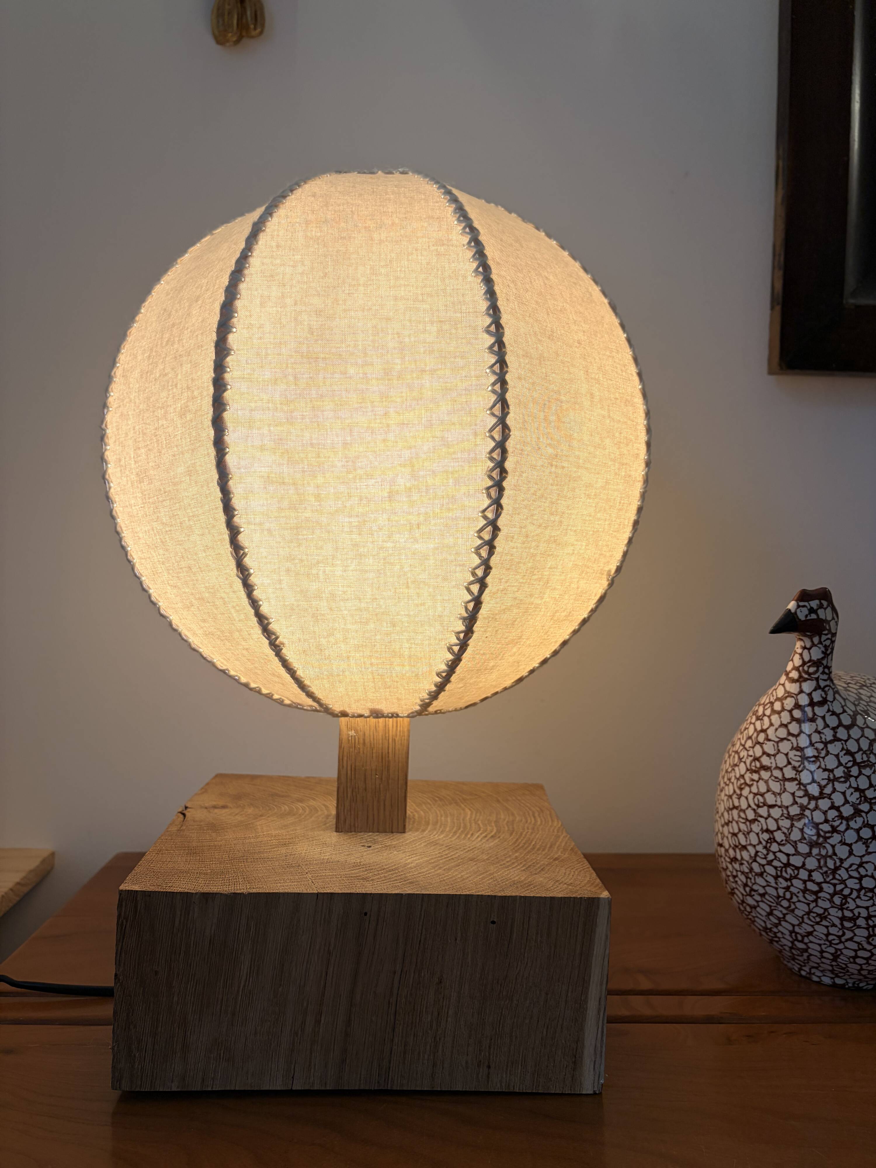 Handmade wooden ball lamp on a stand