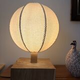 Handmade wooden ball lamp on a stand