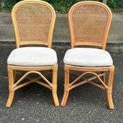 2 rattan and caned chairs in colonial bistro style from the 1990s.