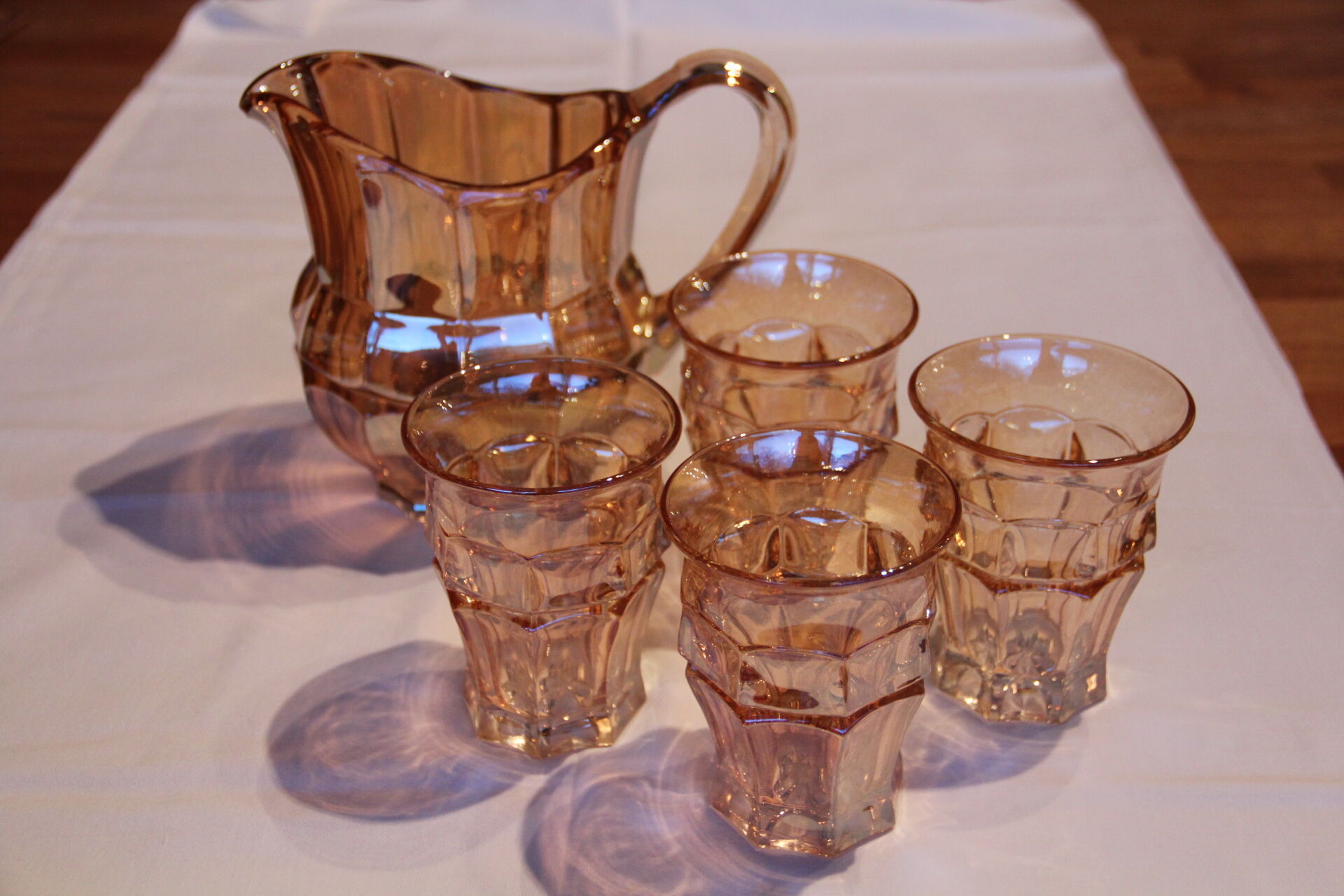 Pourer and her four orange-pink glasses