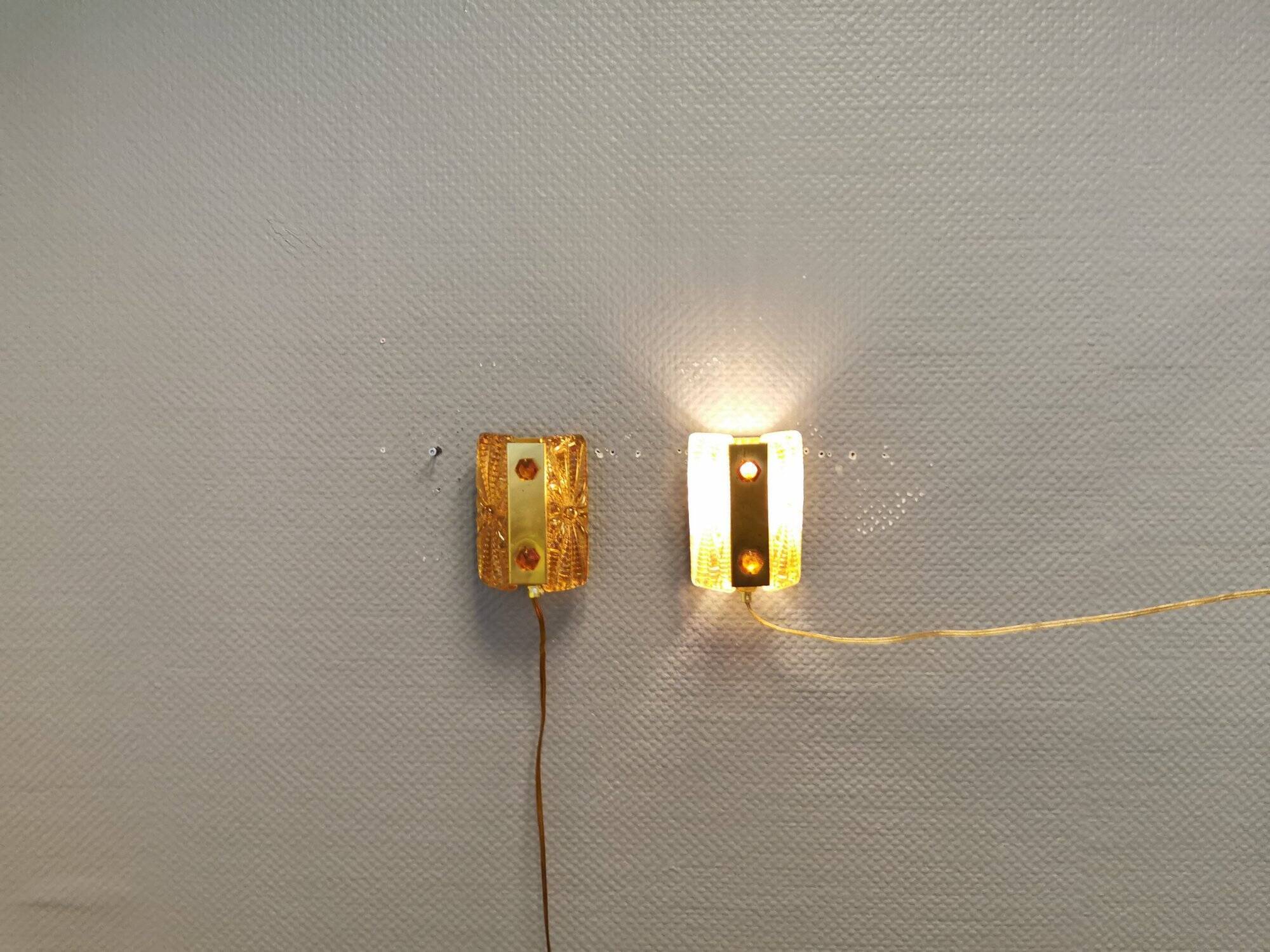 A pair of wall lights with brass-colored suspension with thick pressed glass. Vitrika, Denmark