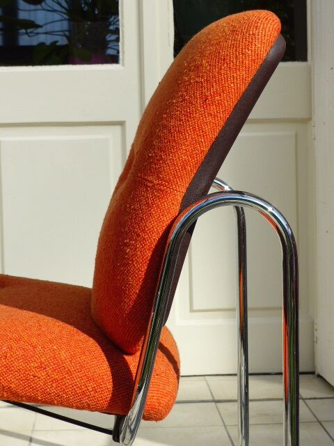 The 1970s orange armchair fabric and chrome metal