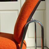 The 1970s orange armchair fabric and chrome metal