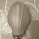 Art Deco wall sconce in frosted pink glass with a seashell design