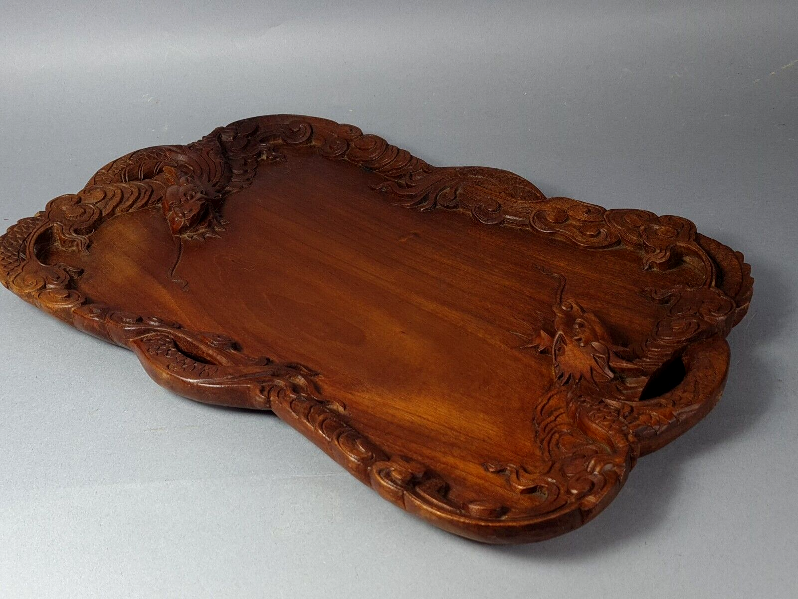 Ancient wooden tray carved with Chinese dragons around 1900