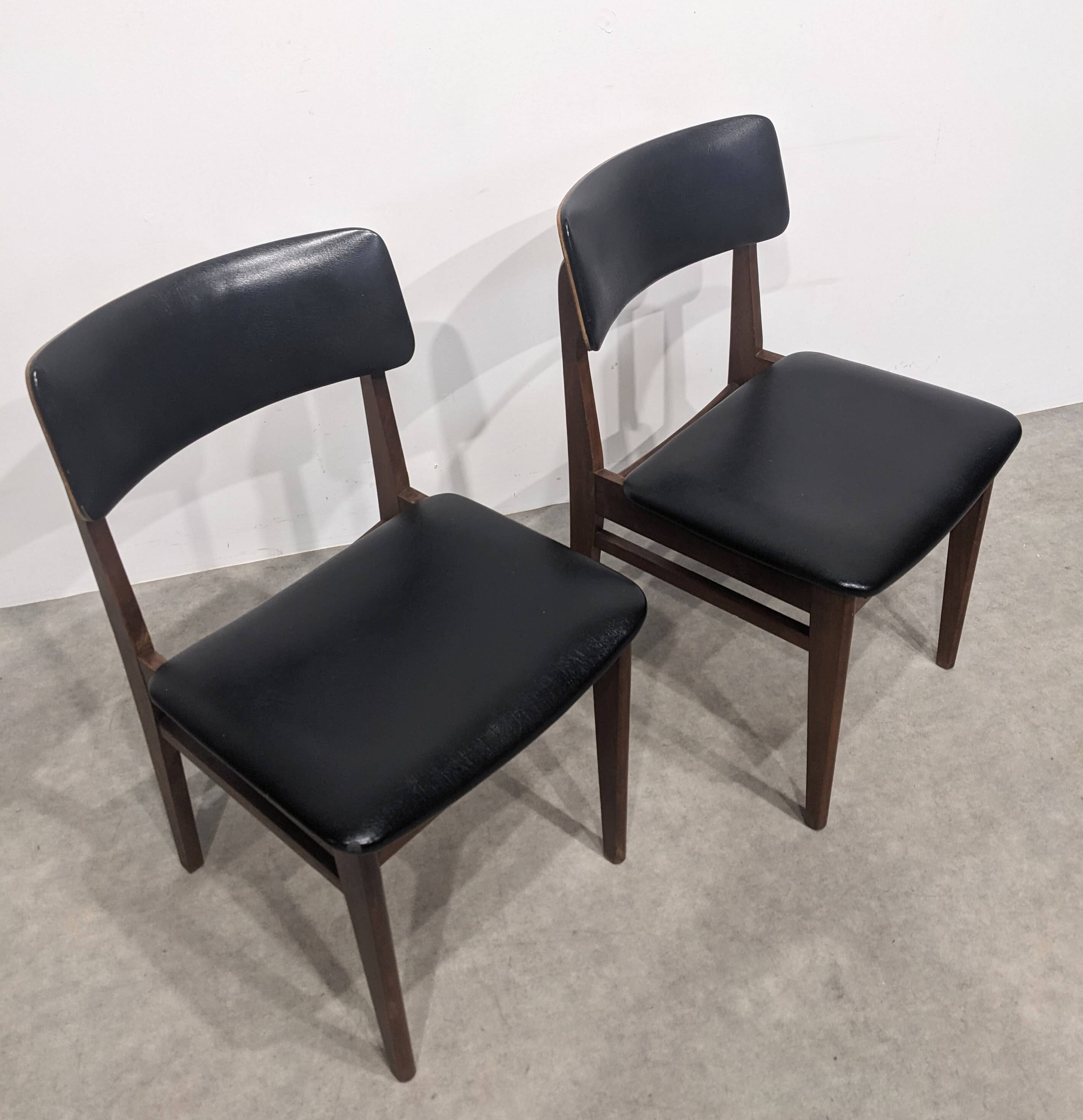 Two mid-century faux leather chairs