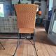 Glass and metal table and its 4 wicker chairs and glass Roche Bobois