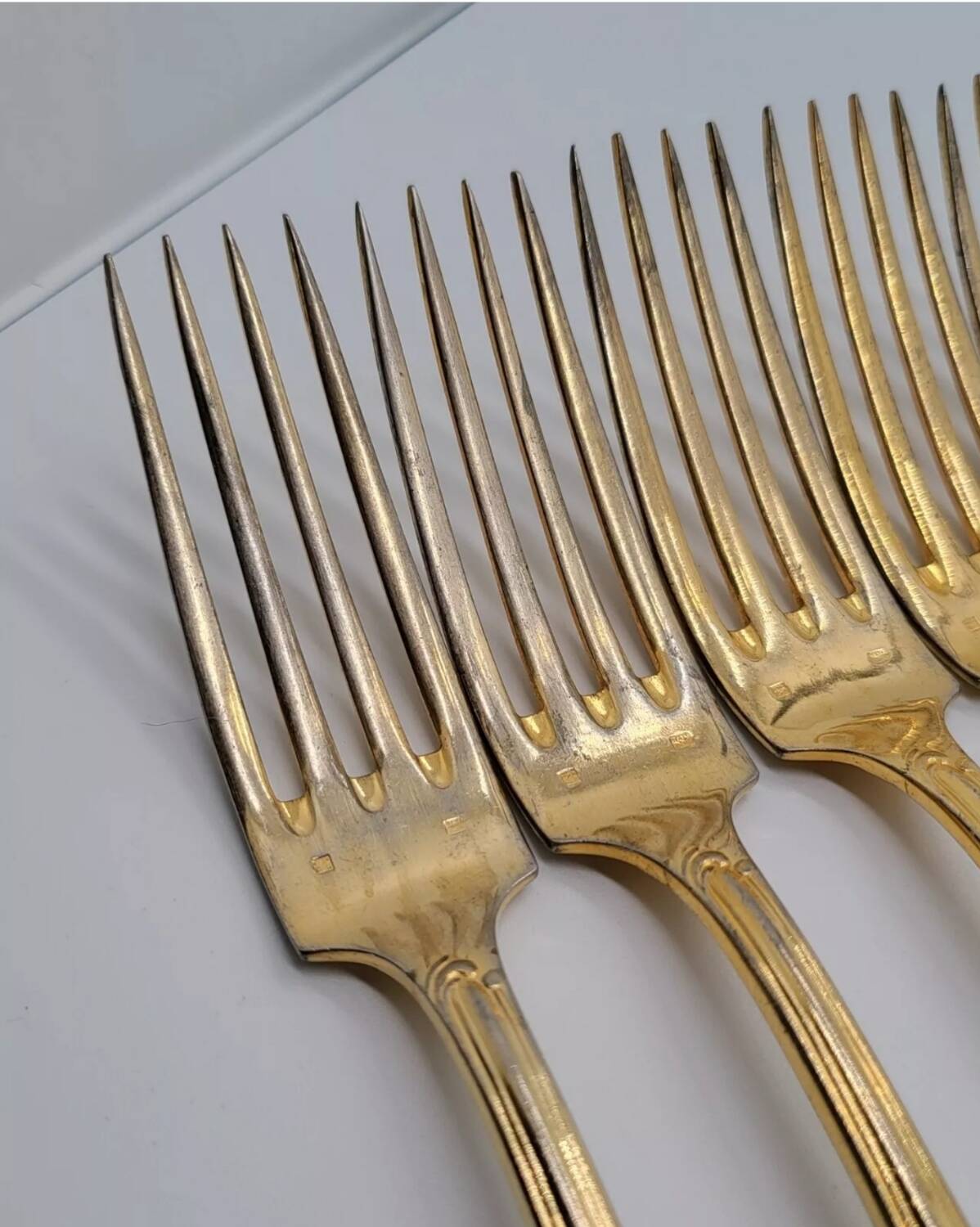 12 Table Forks in gold metal