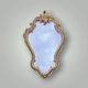 Ancien miroir mural en résine dorée style rococo