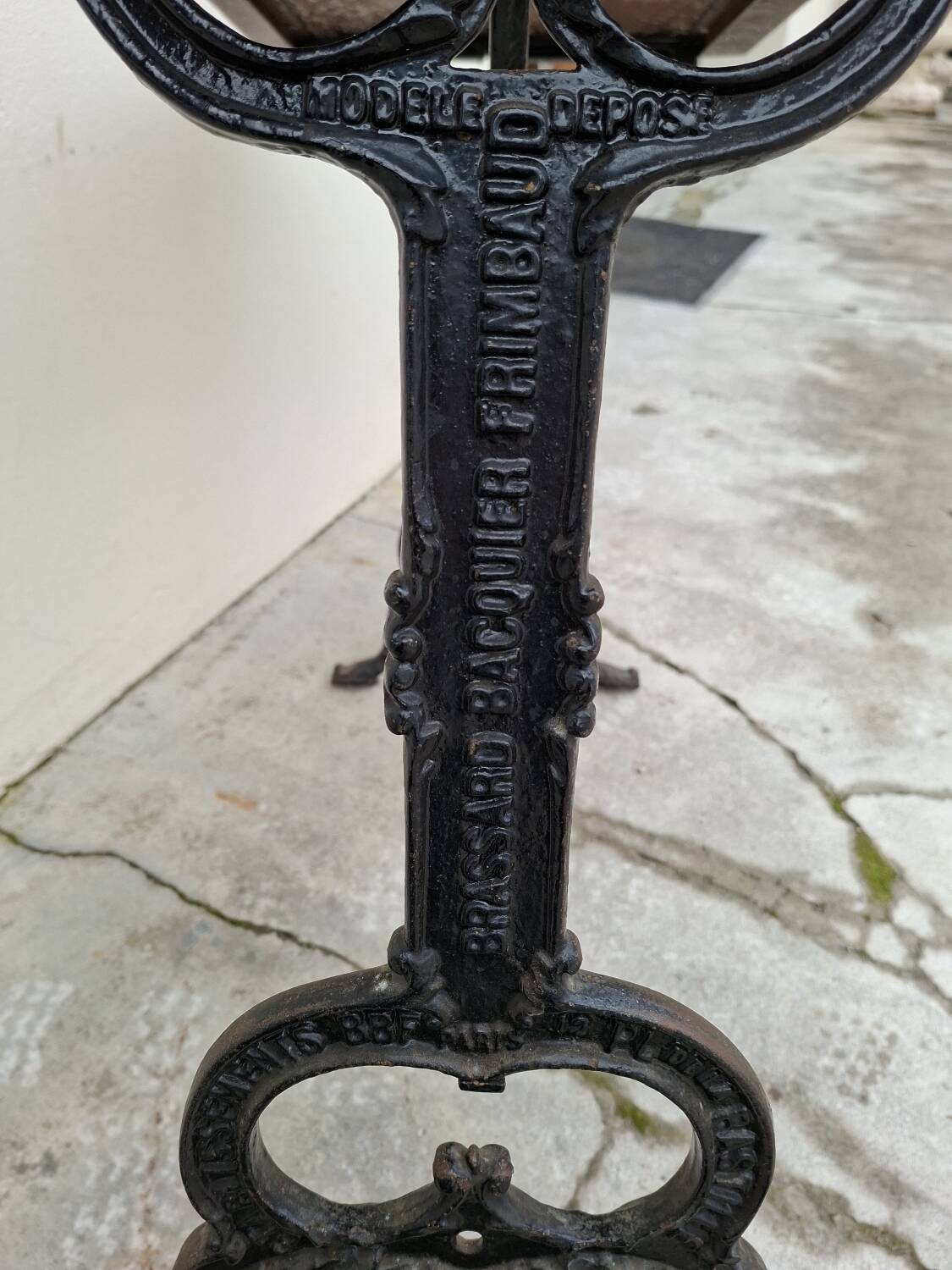 Solid oak bistro table with a cast iron base, signed.