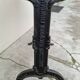 Solid oak bistro table with a cast iron base, signed.