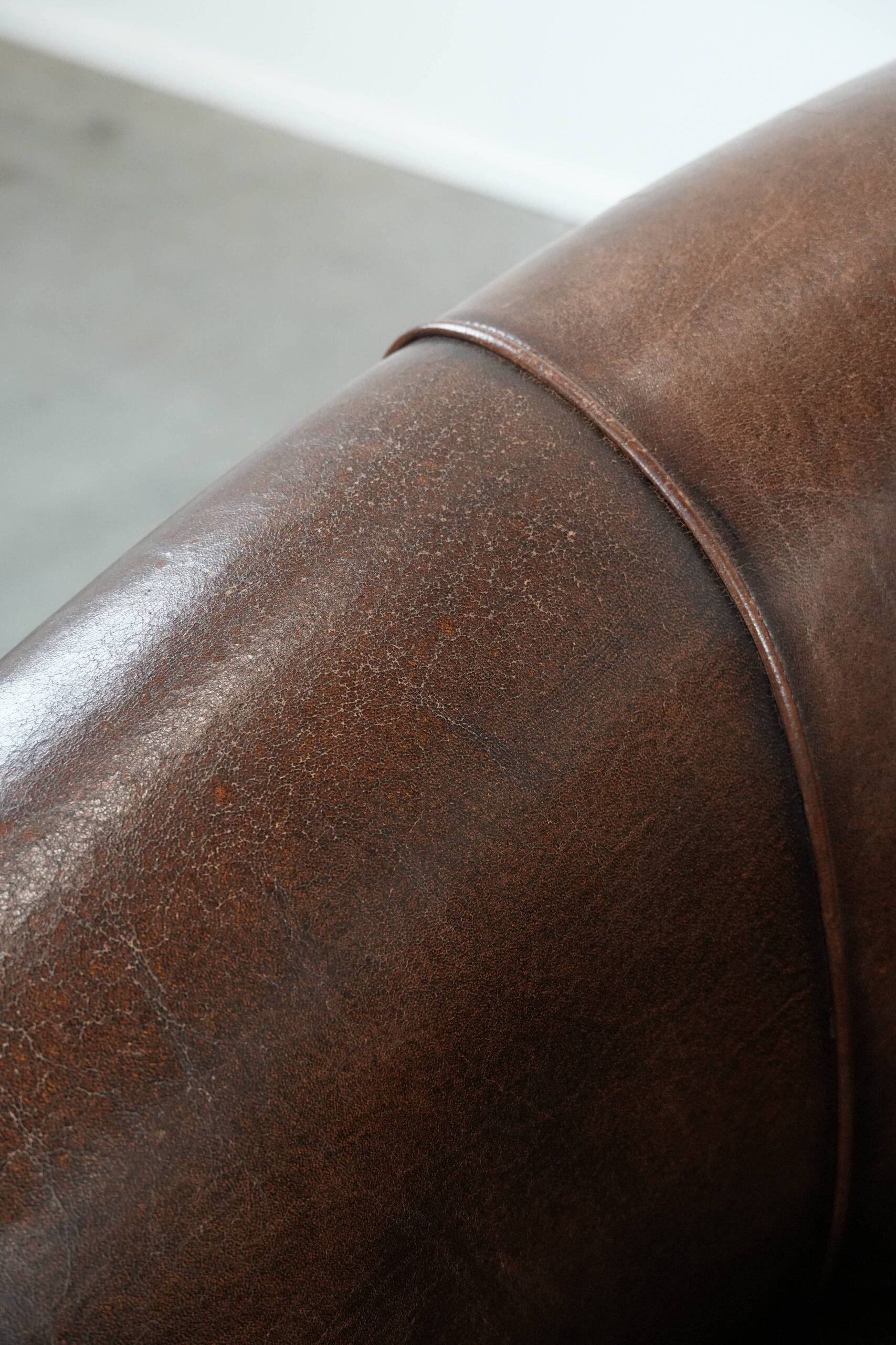 Set of two sheepskin club armchairs with fixed seat cushions