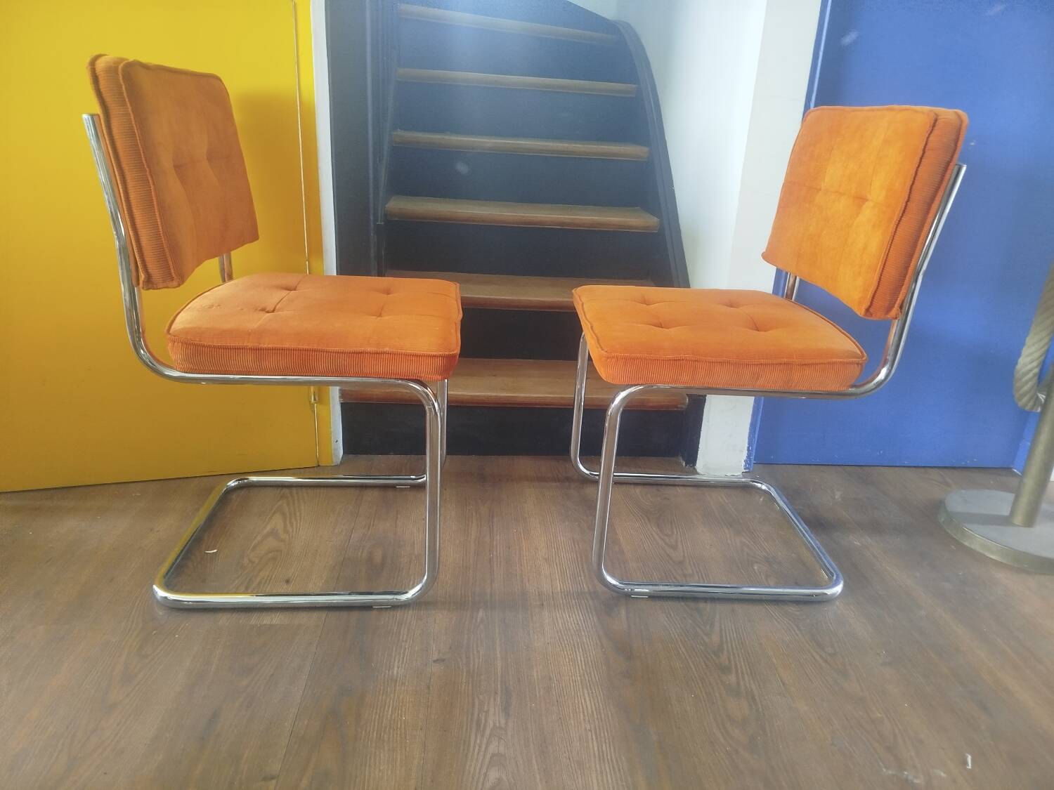 Pair of vintage cantilever chairs in chrome and orange corduroy.