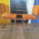Pair of vintage cantilever chairs in chrome and orange corduroy.