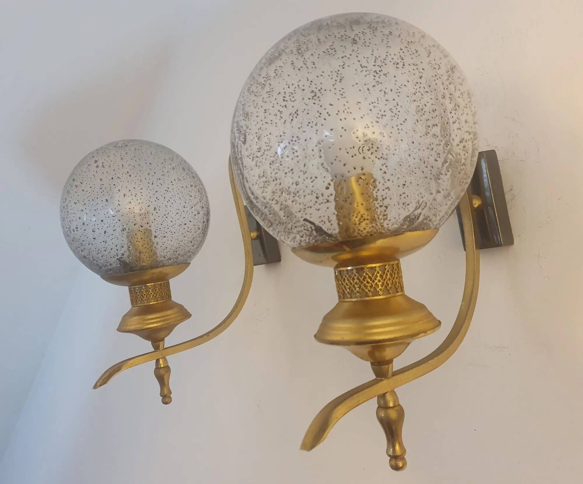 Pair of vintage gold wall sconces with transparent globes