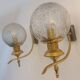 Pair of vintage gold wall sconces with transparent globes