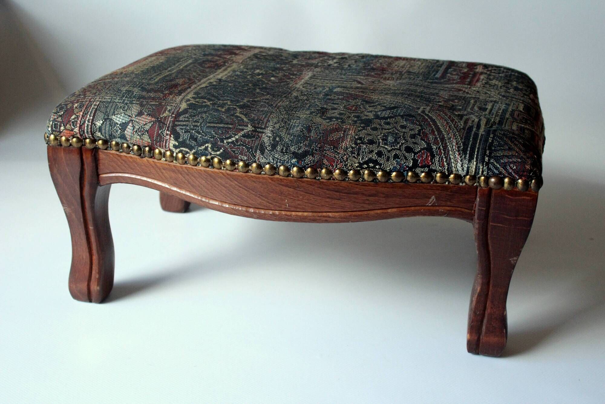 Small foot stool made of wood with upholstery, vintage from the 70s
