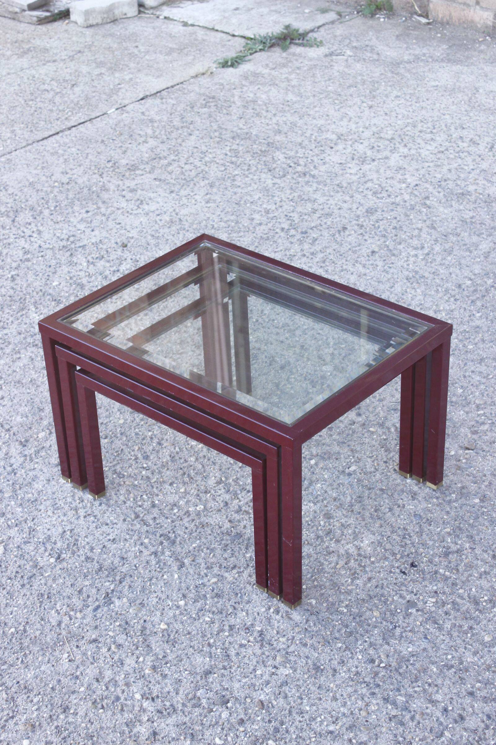 Nesting tables in burgundy lacquered metal and brass, France 1950s