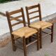2 solid wood and straw chairs