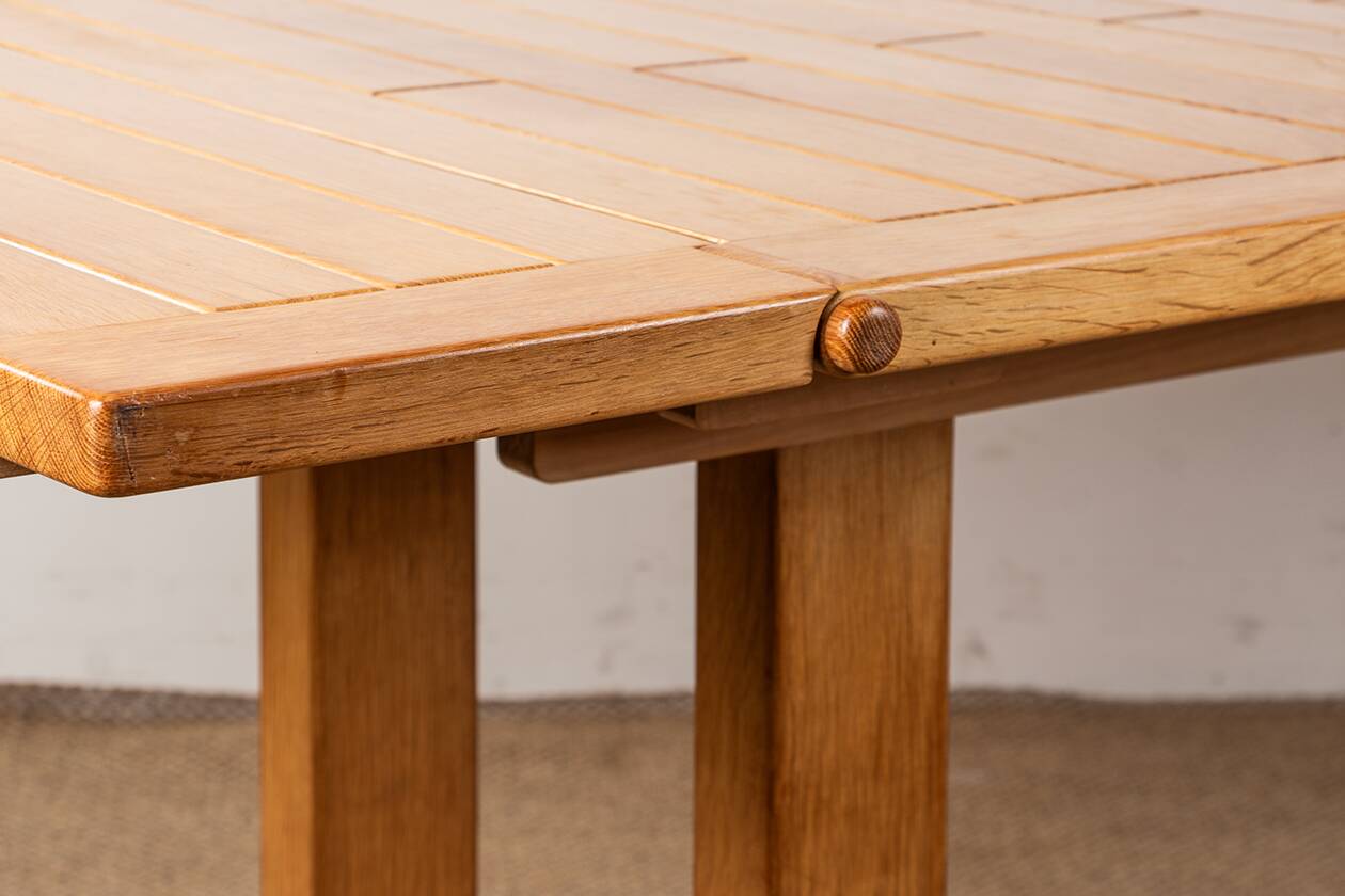 Large extendable dining table in solid oak by Guillerme and Chambron.