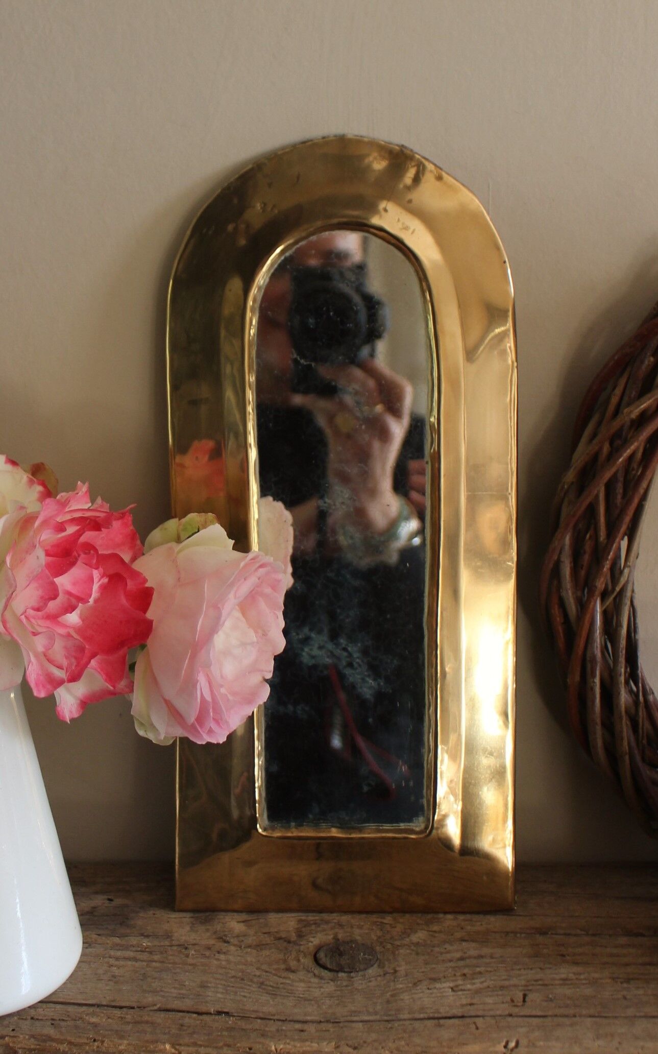 Rounded brass mirror