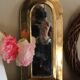 Rounded brass mirror