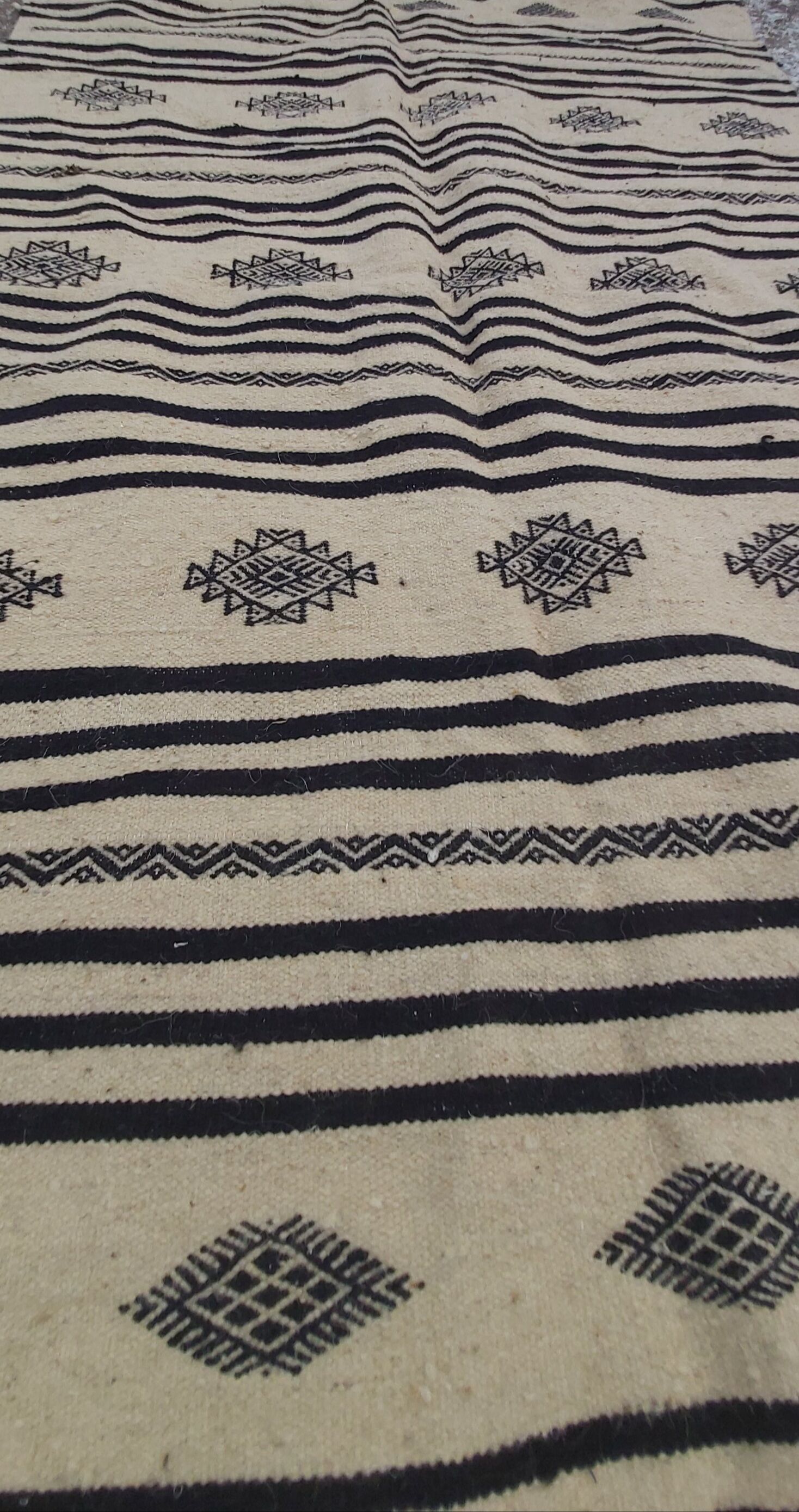 Traditional hand-woven beige and black carpet