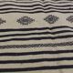 Traditional hand-woven beige and black carpet