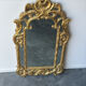 Large mirror with carved and gilded wooden frame, in Regency style.