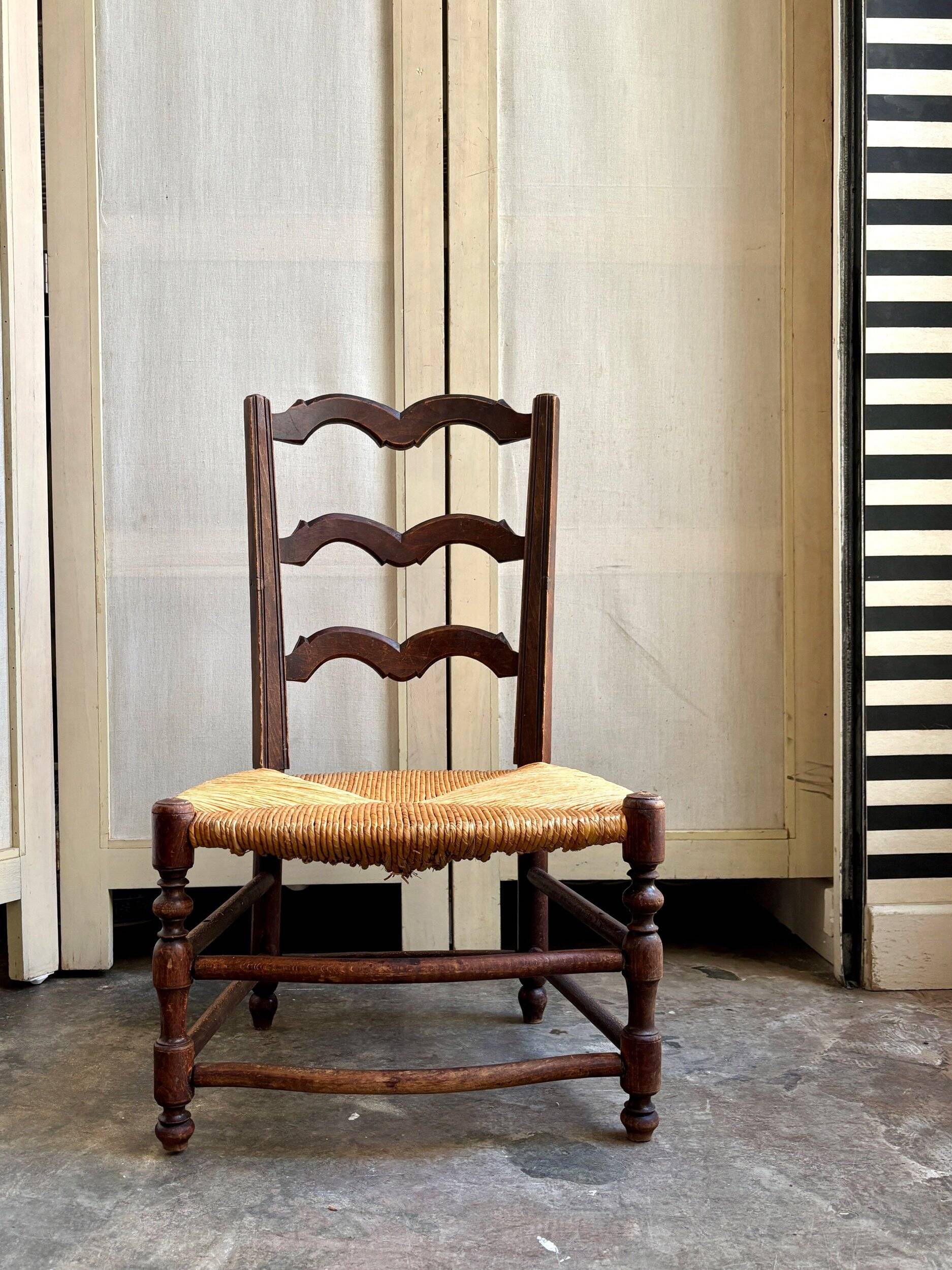 Low Provencal chair in dark wood and woven straw