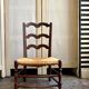 Low Provencal chair in dark wood and woven straw