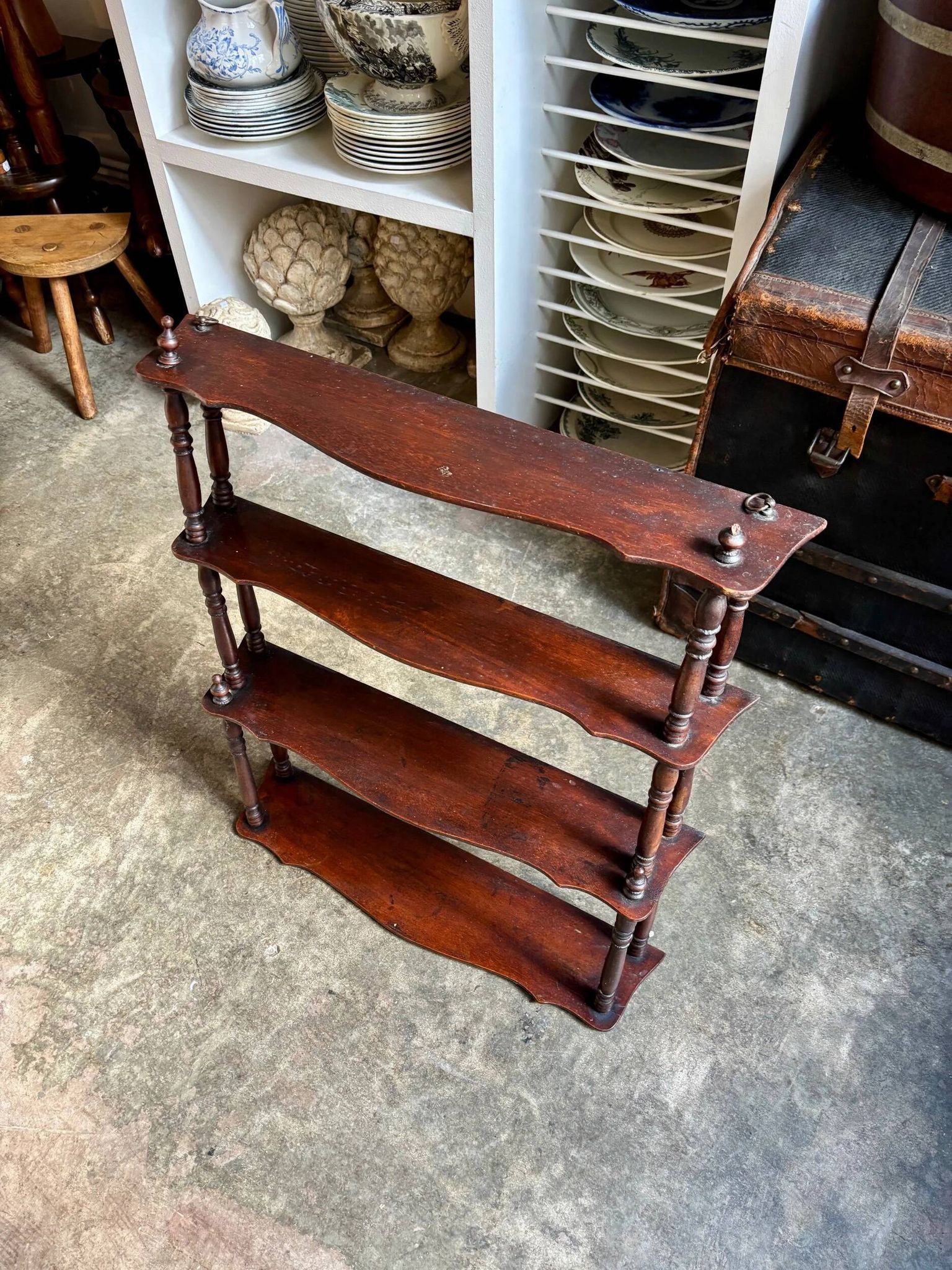 Curved and turned wooden wall shelf