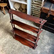 Curved and turned wooden wall shelf